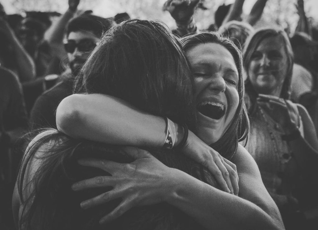 Widespread Panic fans greet each other with a hug