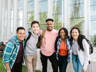 group of smiling students on college campus