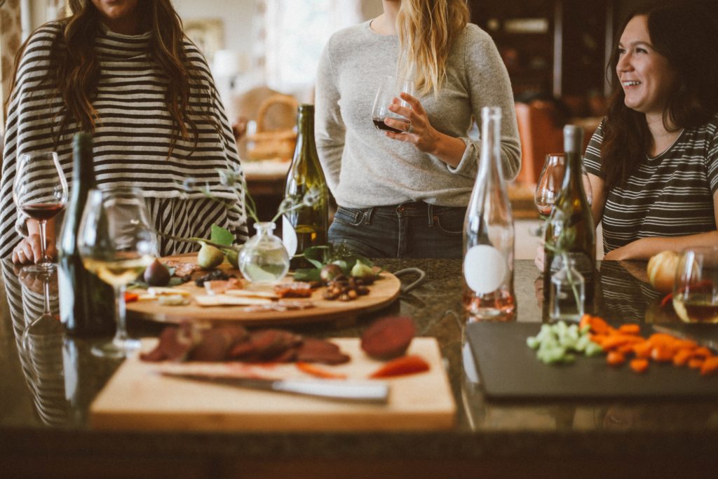 Women in a kitchen for Friendsgiving party
