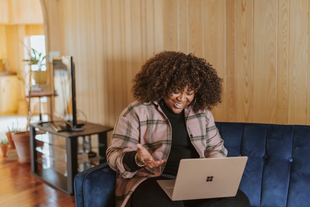 Woman on computer call with friends to  celebrate Friendsgiving