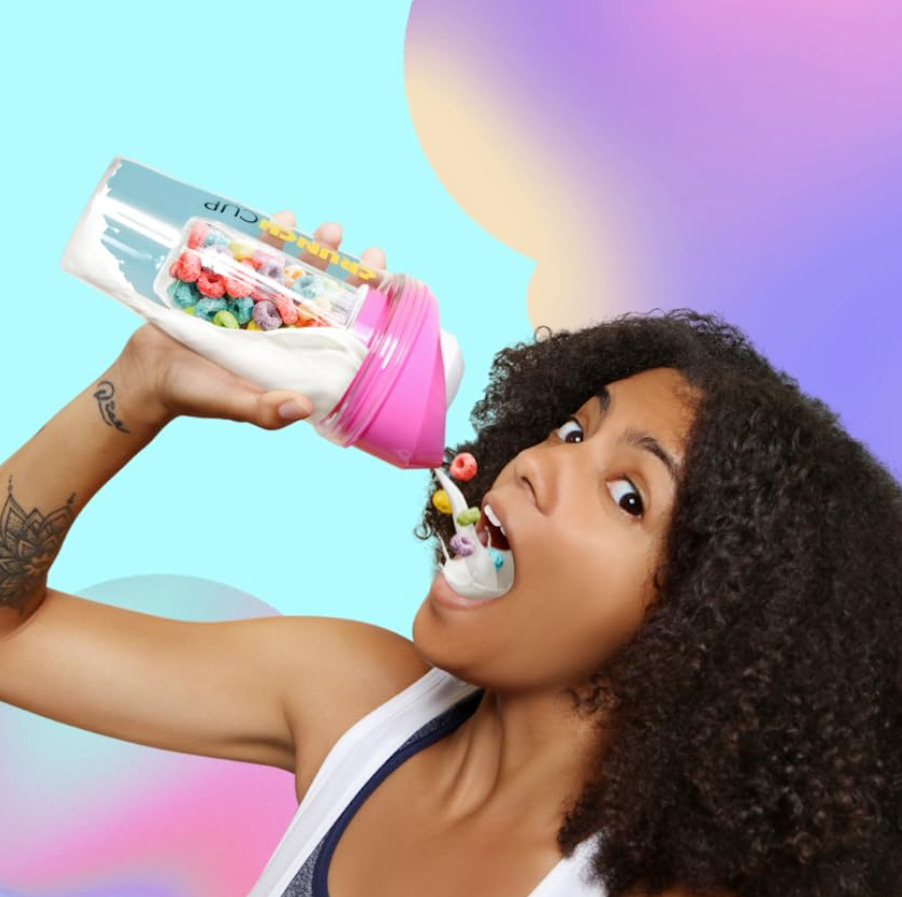 Girl holding cup that is pouring cereal and milk into her mouth as an example of TikTok Gifts