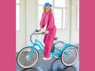 Smiling woman riding an electric tricycle