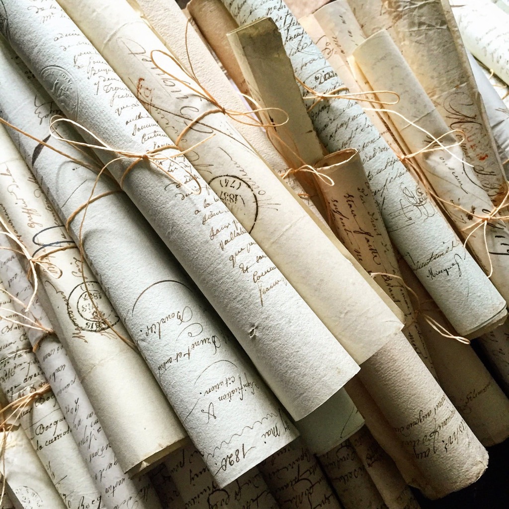 A stack of handwritten letters tied with string
