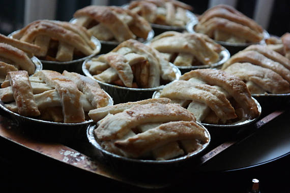 A tray of individual lattice-top mini fruit pies