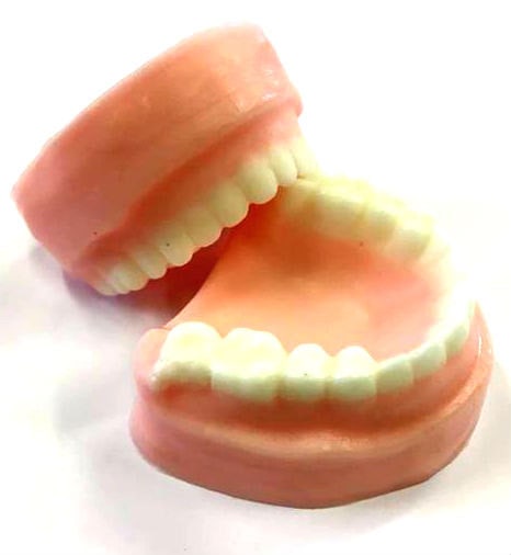 A soap bar molded into the shape of a set of false teeth
