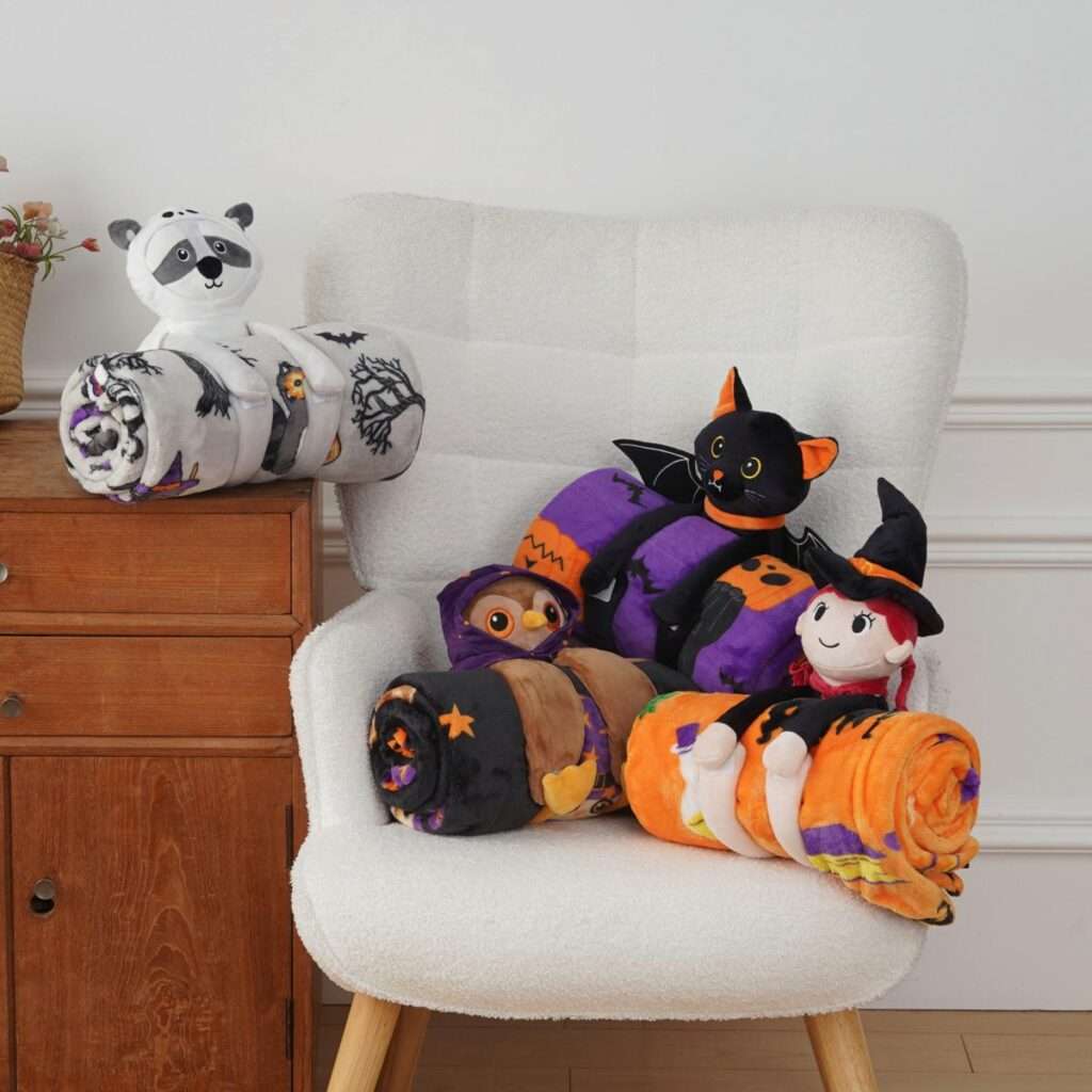 Halloween-themed throw blankets paired with huggable plush animal friends