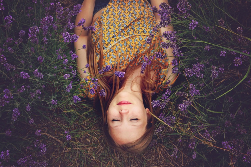 A teen lying in a lavender field, exploring somewhere new